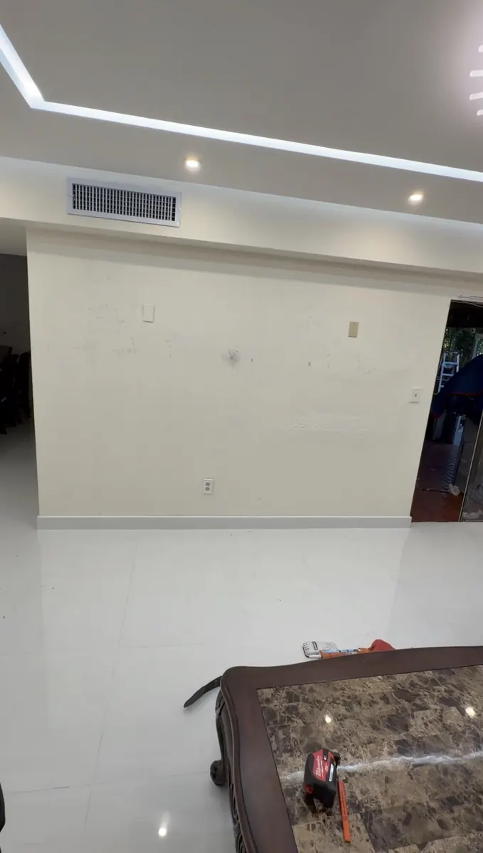 Before: Slat media wall with fireplace